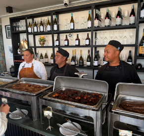 Chefs preparing food at outdoor grills