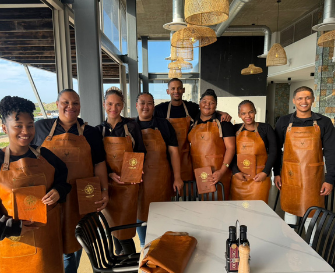 Restaurant team in leather aprons